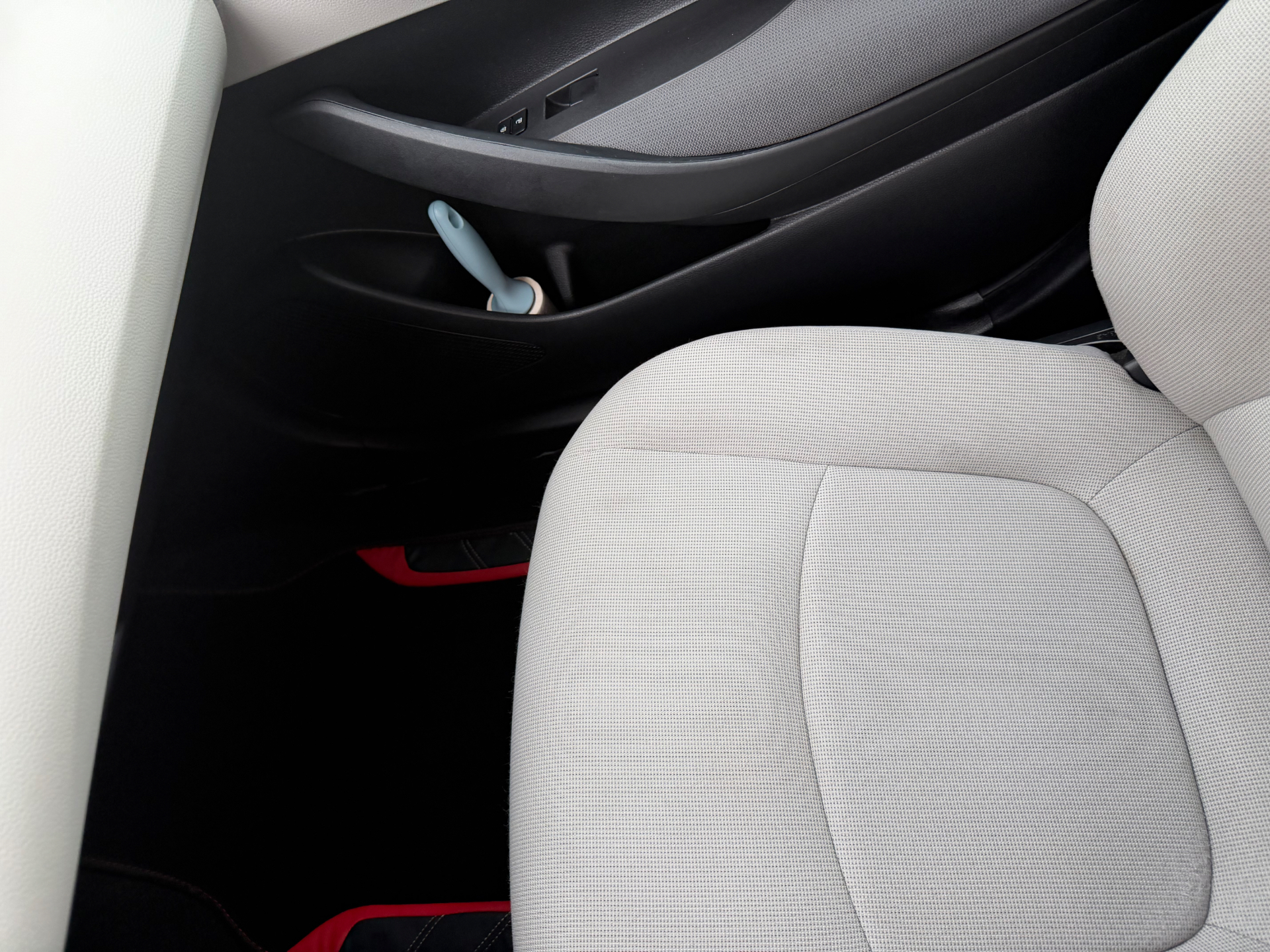 Close-up of a cleaned passenger seat and lower door area