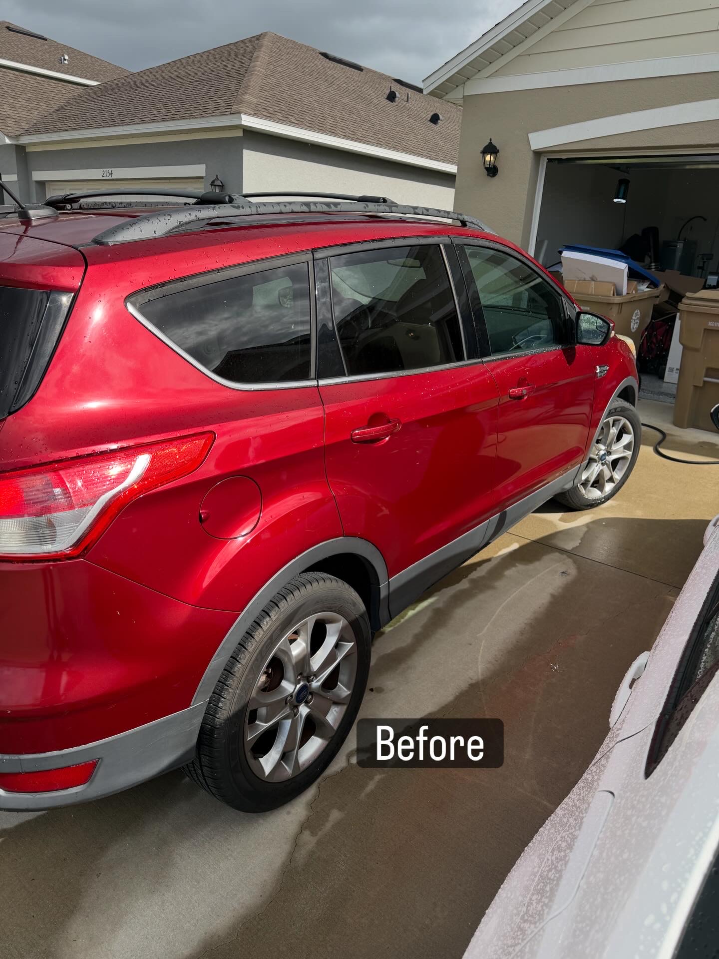 Before exterior photo of a red SUV before detailing